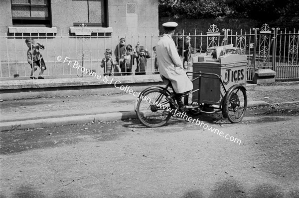 PARISH SCENE ICE CREAM SELLER ON BICYCLE OUTSIDE SCHOOL